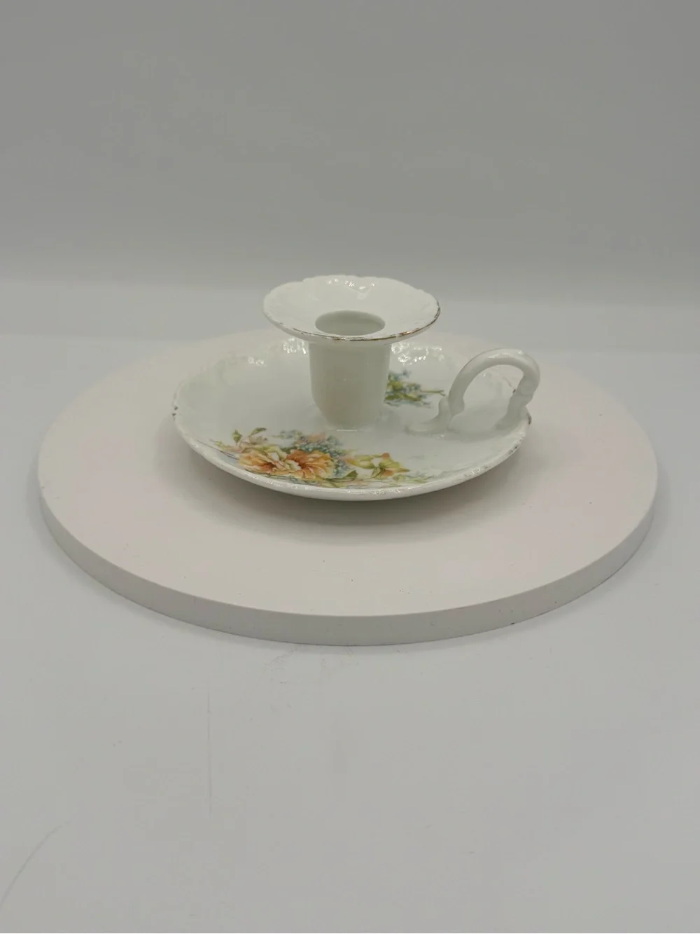 Vintage porcelain taper candle stick holder with floral motif and gold edging